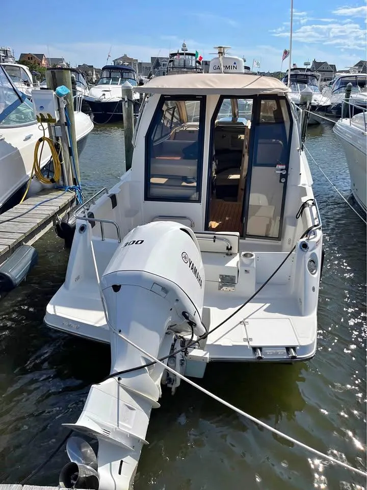 Slide: The Image of 2017 Cutwater C-242 Sport Coupe docked with outboard motor, marina background. - 2