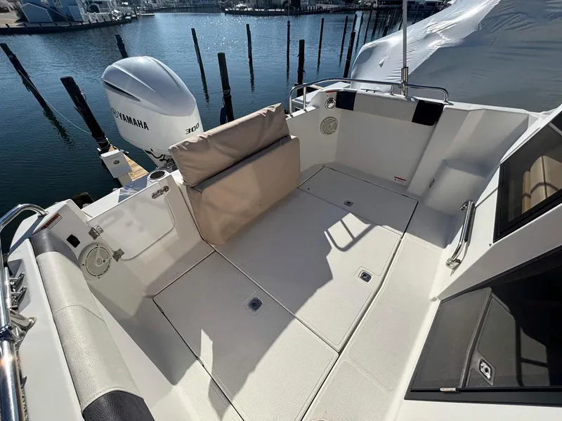 Slide: The Image of 2017 Cutwater C-242 Sport Coupe boat deck with Yamaha engine, docked by the water. - 4