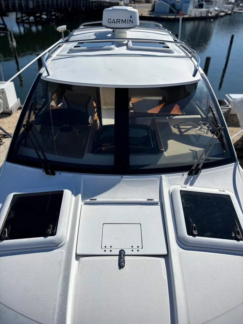 Slide: The Image of 2017 Cutwater C-242 Sport Coupe boat with Garmin navigation, docked at a marina. - 5
