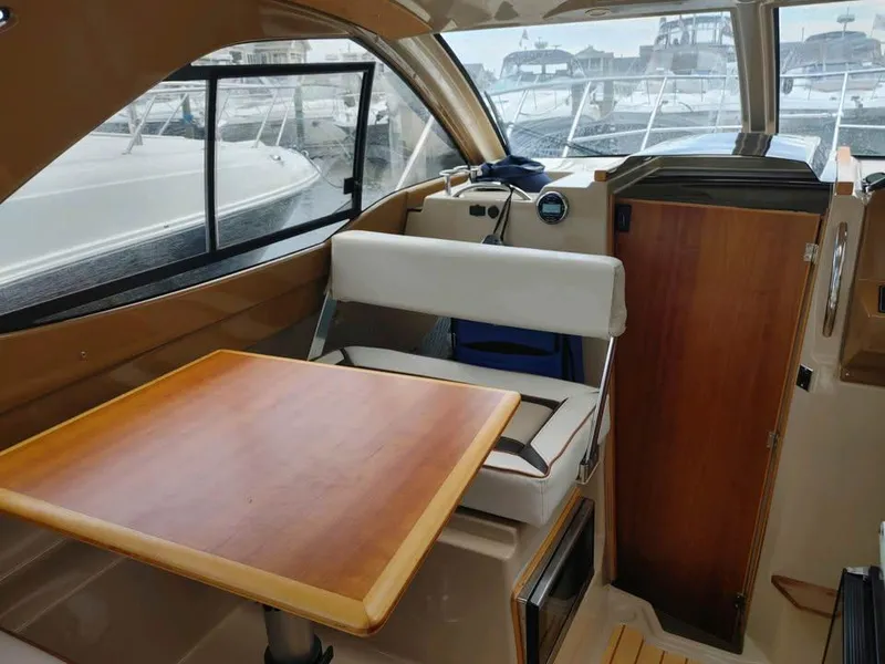 Slide: The Image of 2017 Cutwater C-242 Sport Coupe interior with wooden table and seating. - 9
