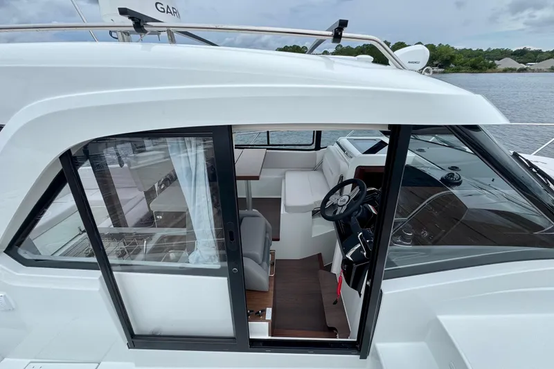 Slide: The Image of 2026 Beneteau Antares 9 boat interior with steering wheel and seating area. - 10