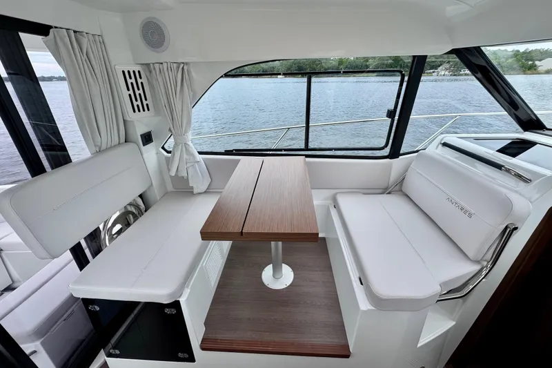 Slide: The Image of Interior of 2026 Beneteau Antares 9, featuring a sleek dining area with lake view. - 14