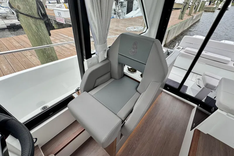 Slide: The Image of Captain's seat in 2026 Beneteau Antares 9 boat interior, featuring sleek design and comfort. - 19