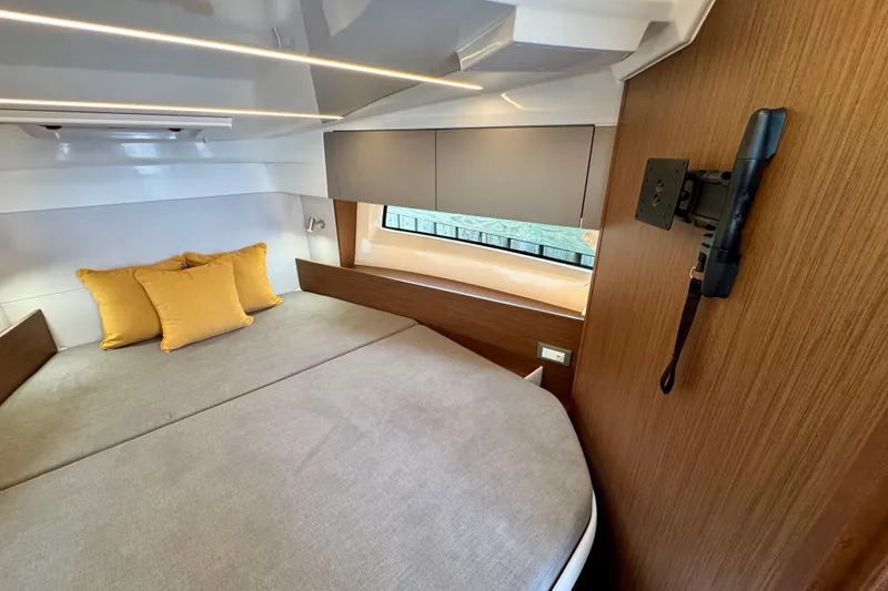 Slide: The Image of Cozy cabin interior of 2026 Beneteau Antares 9 with modern design and yellow cushions. - 22
