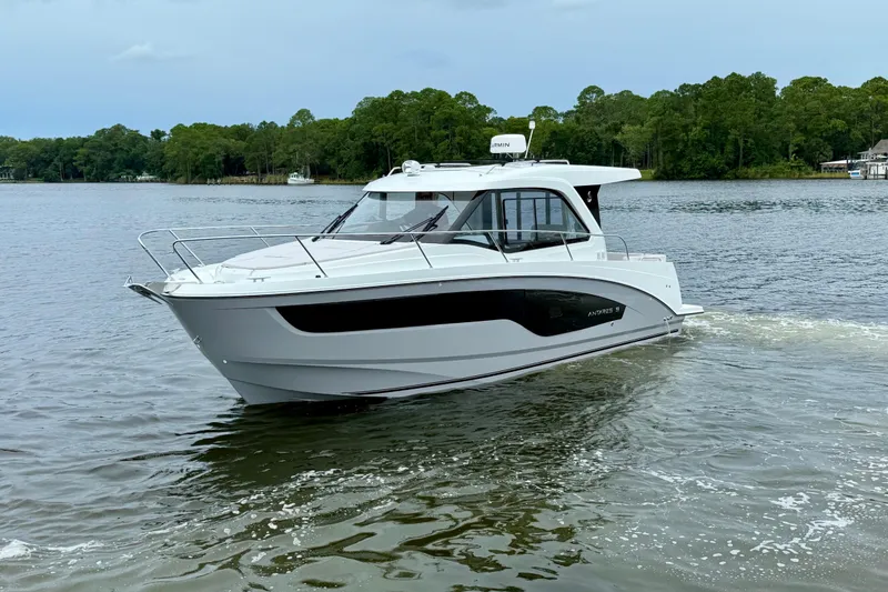 Slide: The Image of 2026 Beneteau Antares 9 cruising on a serene lake with lush green trees. - 5