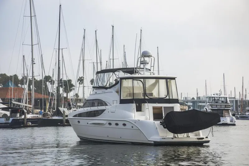 Slide: The Image of 2005 Meridian 459 Motoryacht docked in a marina with sailboats in the background. - 11
