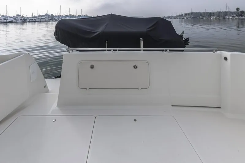 Slide: The Image of 2005 Meridian 459 Motoryacht deck with covered equipment, docked in a calm marina. - 12
