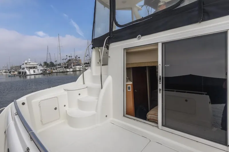 Slide: The Image of 2005 Meridian 459 Motoryacht docked, featuring sleek design and spacious interior. - 13