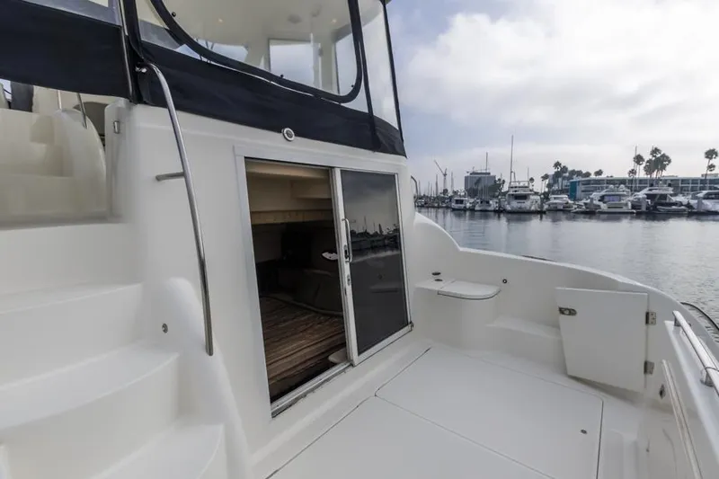Slide: The Image of 2005 Meridian 459 Motoryacht docked, showing open cabin door and marina view. - 14