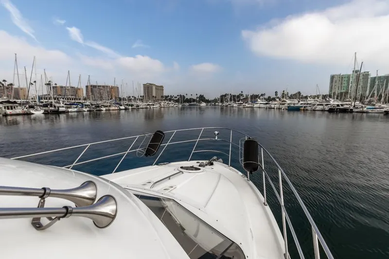 Slide: The Image of 2005 Meridian 459 Motoryacht in marina, surrounded by sailboats and cityscape under blue sky. - 16