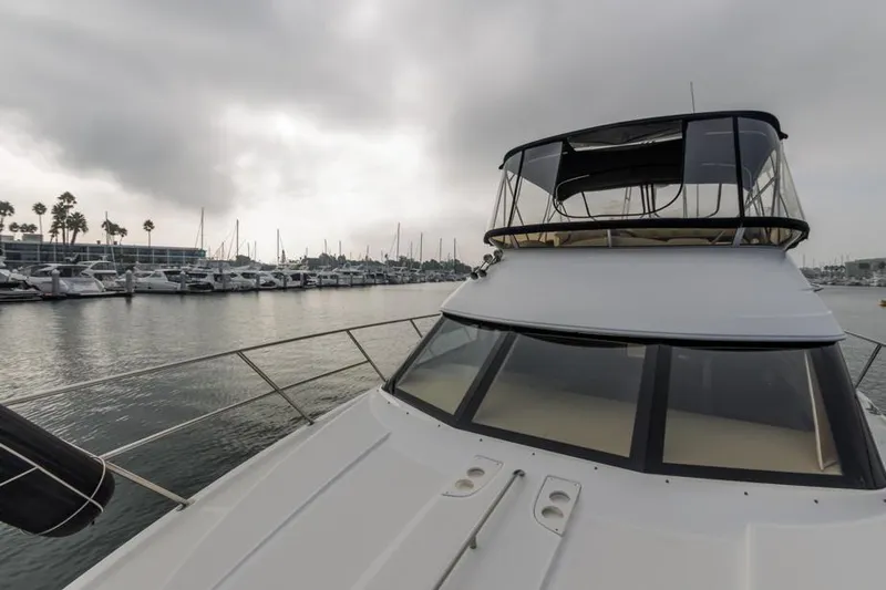 Slide: The Image of 2005 Meridian 459 Motoryacht docked in a marina under cloudy skies. - 18