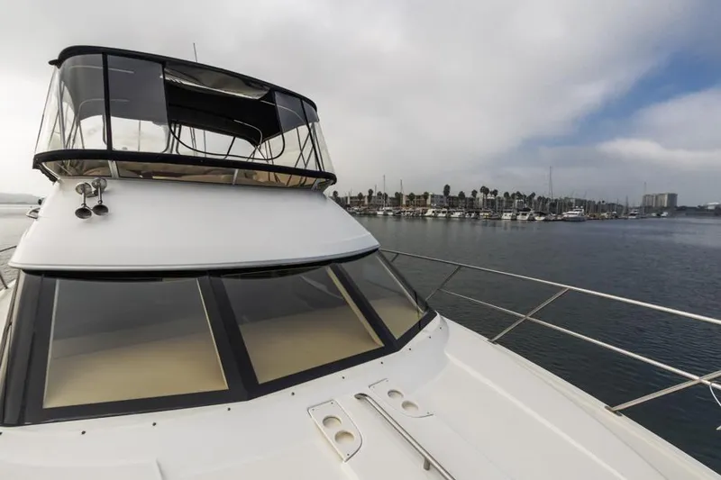 Slide: The Image of 2005 Meridian 459 Motoryacht on calm water with marina in background. - 19