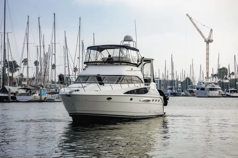 Slide: The Image of 2005 Meridian 459 Motoryacht in marina, surrounded by sailboats and cranes. - 2