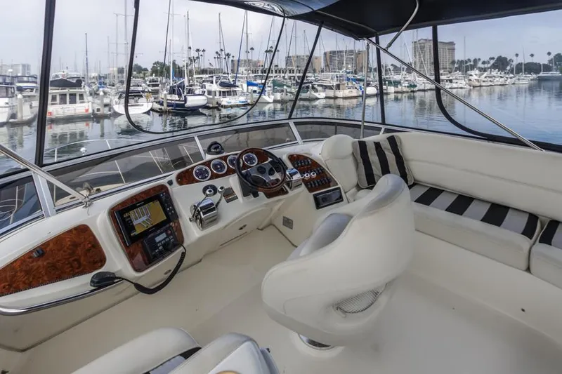 Slide: The Image of 2005 Meridian 459 Motoryacht cockpit with modern controls and marina view. - 21
