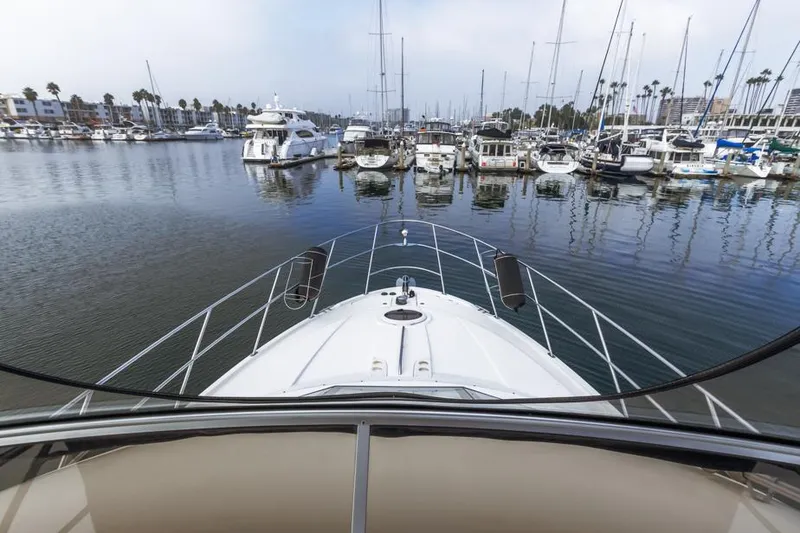 Slide: The Image of 2005 Meridian 459 Motoryacht docked in a marina with surrounding boats. - 23