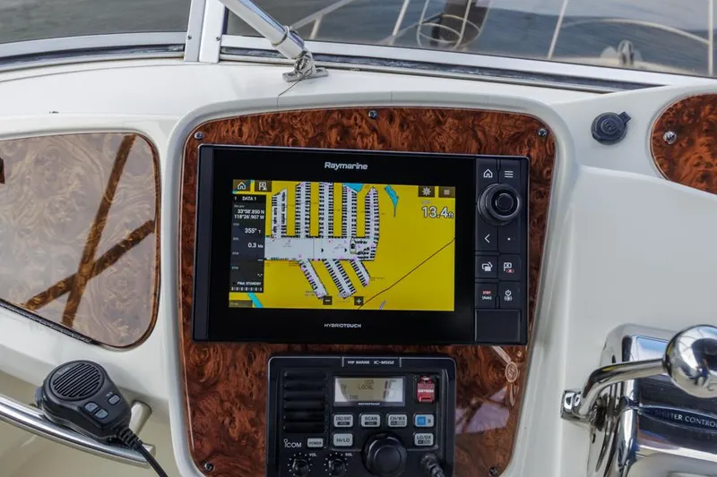 Slide: The Image of 2005 Meridian 459 Motoryacht dashboard with Raymarine navigation system and controls. - 24