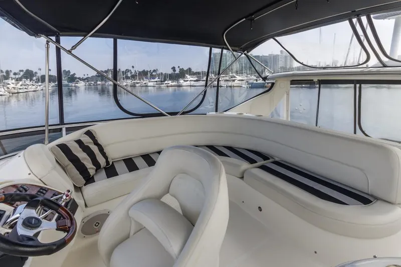Slide: The Image of 2005 Meridian 459 Motoryacht interior with plush seating and marina view. - 25