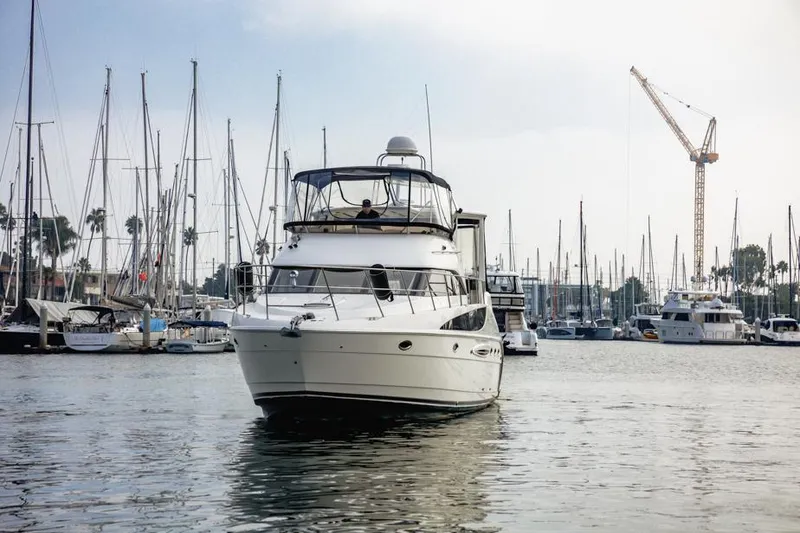 Slide: The Image of 2005 Meridian 459 Motoryacht in marina, surrounded by sailboats and cranes. - 3