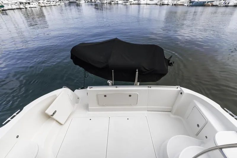 Slide: The Image of 2005 Meridian 459 Motoryacht stern view at marina, featuring spacious deck and covered equipment. - 30