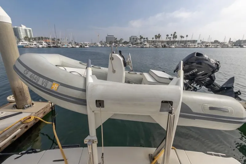 Slide: The Image of Inflatable boat docked near a 2005 Meridian 459 Motoryacht in a marina setting. - 31