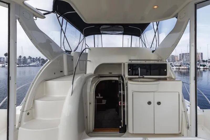 Slide: The Image of 2005 Meridian 459 Motoryacht interior with stairs, cabinets, and marina view. - 33