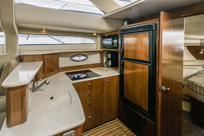 Slide: The Image of Luxurious kitchen interior of 2005 Meridian 459 Motoryacht with wood cabinetry and modern appliances. - 37