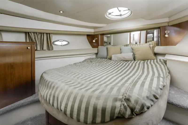 Slide: The Image of Luxurious bedroom interior of 2005 Meridian 459 Motoryacht with striped bedding and porthole windows. - 39