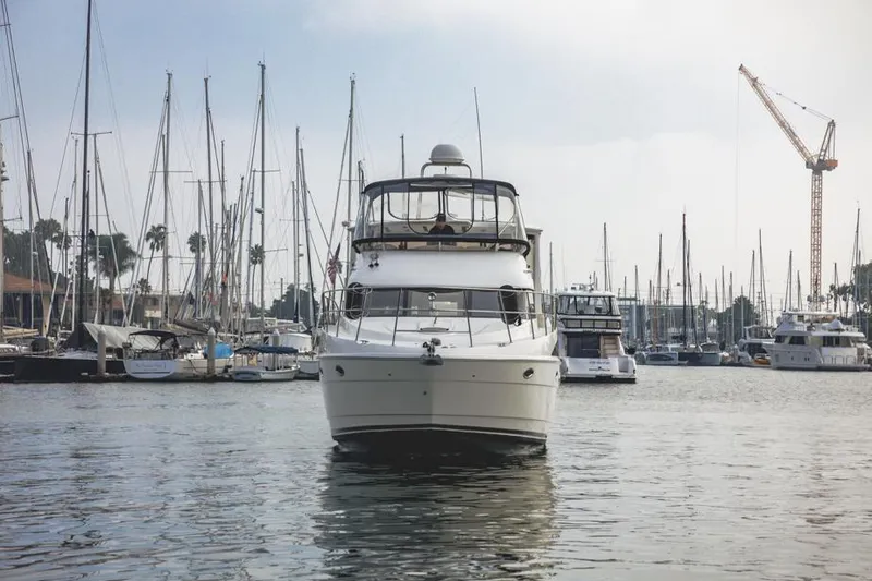 Slide: The Image of 2005 Meridian 459 Motoryacht docked in a marina with sailboats and cranes. - 4