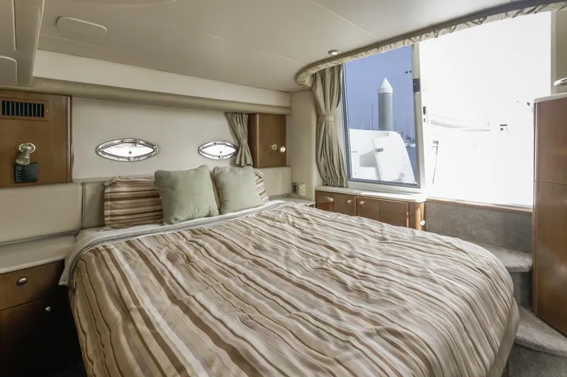 Slide: The Image of Luxurious bedroom interior of 2005 Meridian 459 Motoryacht with striped bedding and large window. - 47