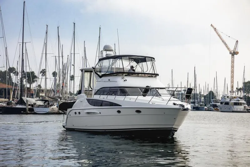 Slide: The Image of 2005 Meridian 459 Motoryacht in marina, surrounded by sailboats and cranes. - 5