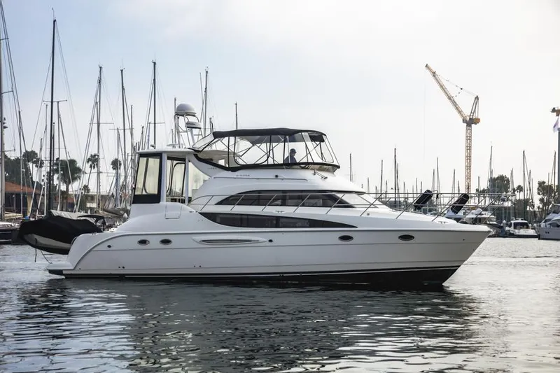 Slide: The Image of 2005 Meridian 459 Motoryacht docked in marina, surrounded by sailboats and cranes. - 7