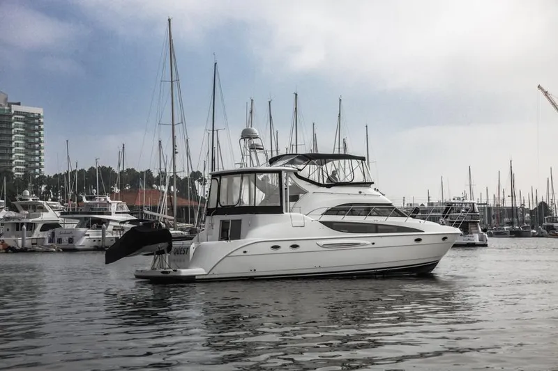 Slide: The Image of 2005 Meridian 459 Motoryacht docked in a marina, surrounded by sailboats. - 8