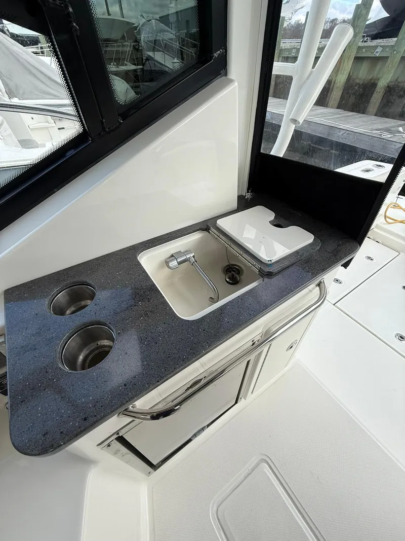 Slide: The Image of 2020 Boston Whaler 325 Conquest boat kitchenette with sink and storage. - 10