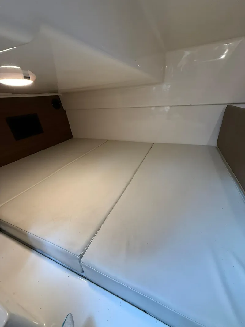 Slide: The Image of 2020 Boston Whaler 325 Conquest cabin interior with cushioned seating. - 23