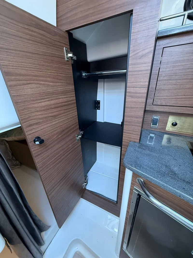 Slide: The Image of 2020 Boston Whaler 325 Conquest interior closet with wooden finish and modern design. - 25