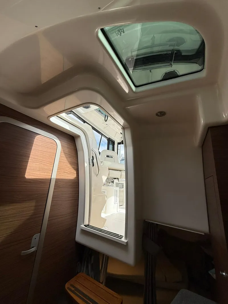 Slide: The Image of Interior view of 2020 Boston Whaler 325 Conquest with skylight and wooden accents. - 28
