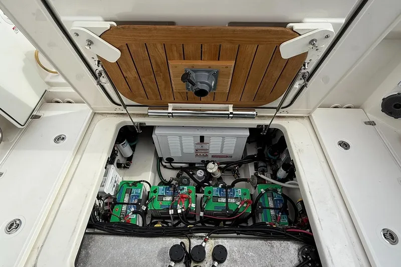 Slide: The Image of 2020 Boston Whaler 325 Conquest engine compartment with batteries and wiring. - 36