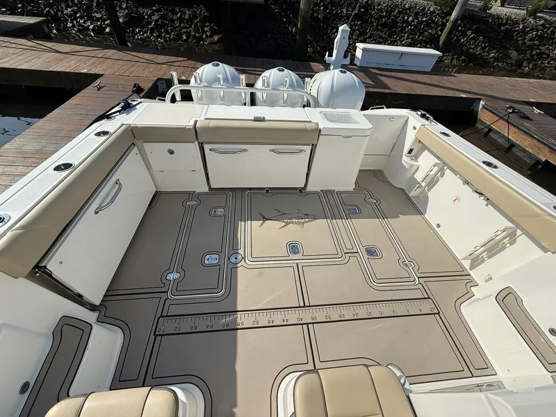 Slide: The Image of 2020 Boston Whaler 325 Conquest boat deck with seating and storage compartments. - 38