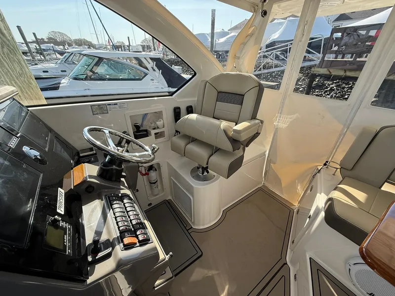 Slide: The Image of Interior of 2020 Boston Whaler 325 Conquest boat with helm and captain's chair. - 40
