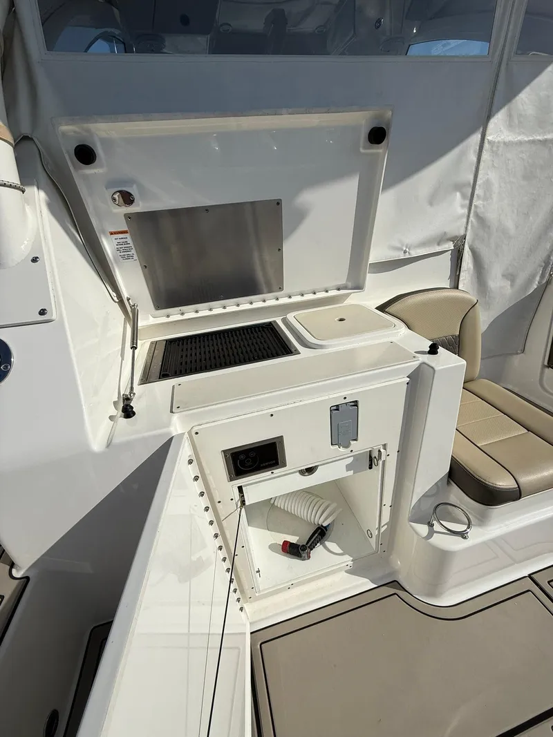Slide: The Image of 2020 Boston Whaler 325 Conquest interior with seating and storage compartments. - 41