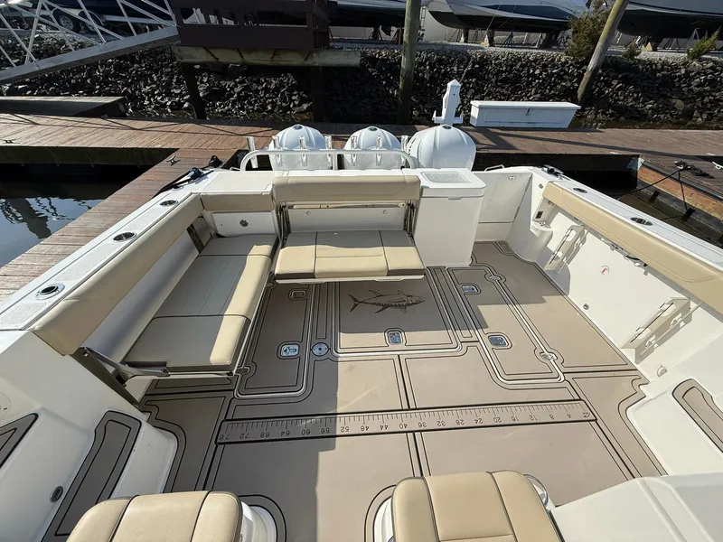 Slide: The Image of 2020 Boston Whaler 325 Conquest boat deck with seating and storage at a dock. - 42