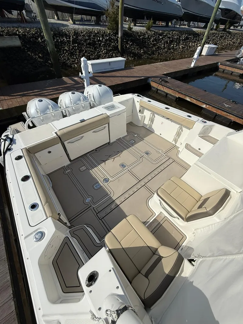 Slide: The Image of 2020 Boston Whaler 325 Conquest boat interior with seating and twin engines. - 44