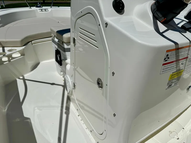 Slide: The Image of 2024 Boston Whaler 190 Montauk boat interior with storage compartment and seating area. - 12