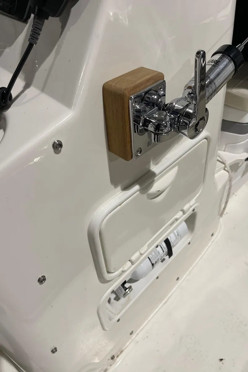 Slide: The Image of 2024 Boston Whaler 190 Montauk boat console with control lever and storage compartments. - 13