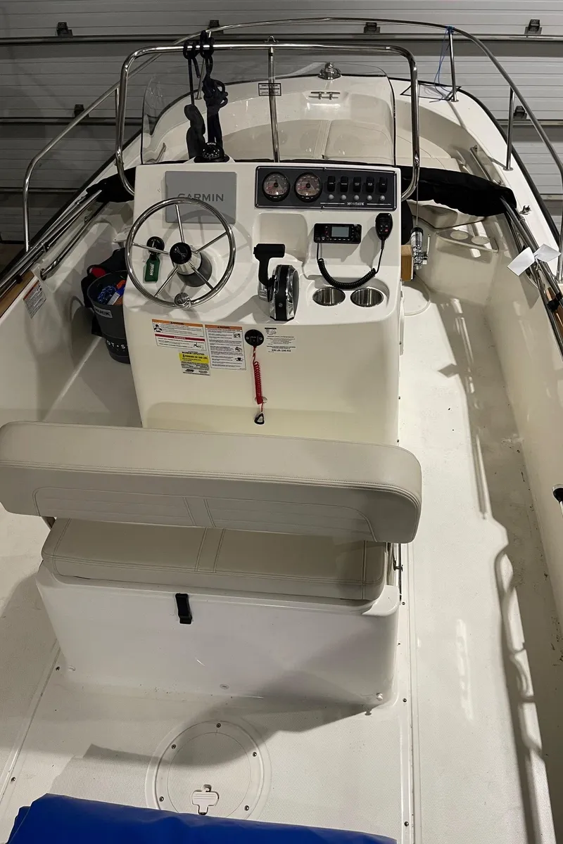 Slide: The Image of 2024 Boston Whaler 190 Montauk boat interior with steering console and seating. - 17