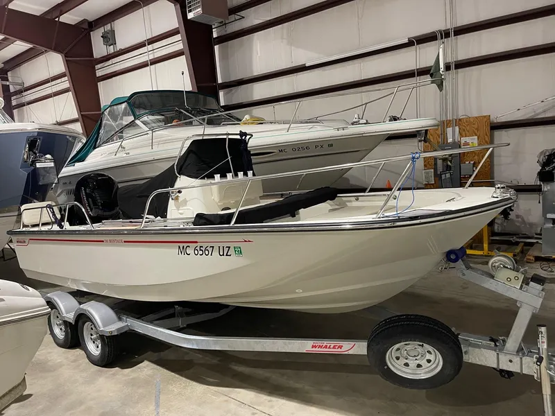Slide: The Image of 2024 Boston Whaler 190 Montauk boat on trailer in indoor storage. - 20