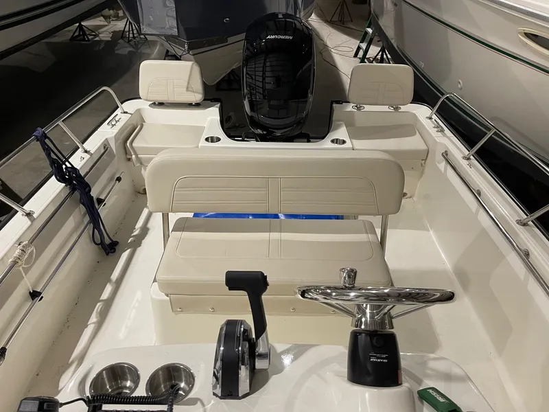 Slide: The Image of 2024 Boston Whaler 190 Montauk boat interior with steering wheel and seating. - 7