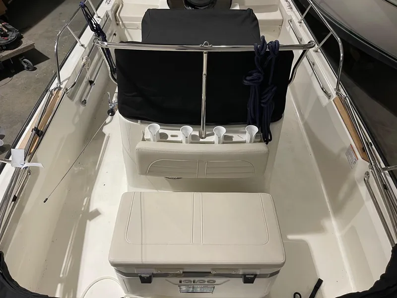 Slide: The Image of 2024 Boston Whaler 190 Montauk interior with seating and storage features. - 8