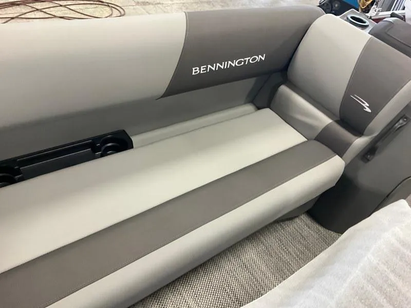 Slide: The Image of 2024 Bennington 20 SVSR SPS boat interior with gray seating and logo. - 11