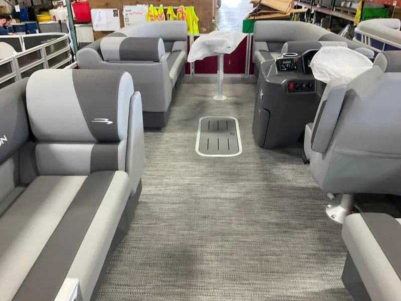 Slide: The Image of 2024 Bennington 20 SVSR SPS pontoon boat interior with gray seating and modern dashboard. - 6